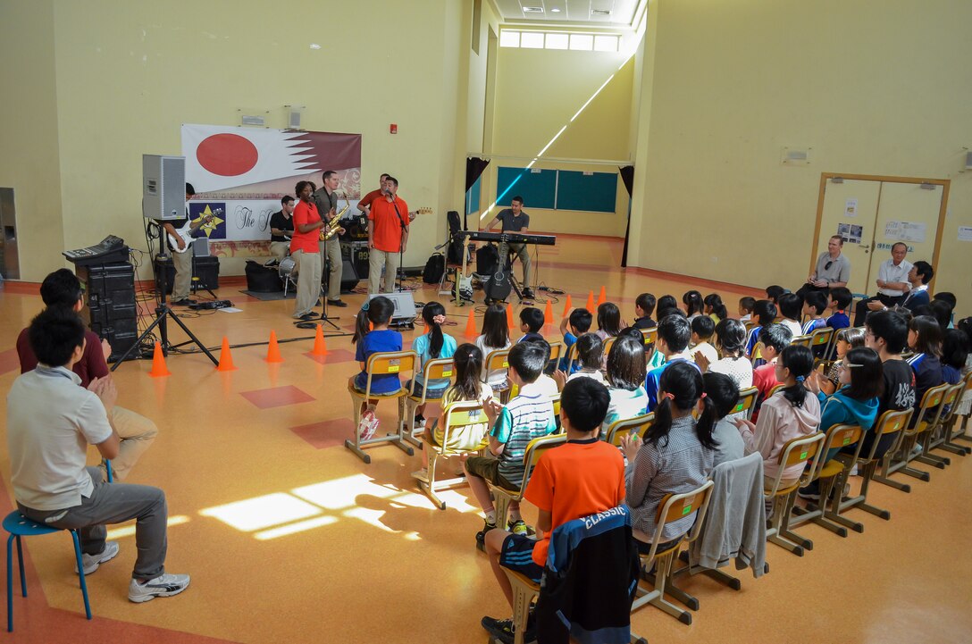 Members of the Air Forces Central Command’s band, “Hypersonic,” play a song for children, parents and faculty of the Japan School of Doha, Qatar, April 23, 2014. The band’s mission, which is to promote troop morale, diplomacy and outreach to host nation communities, touched home when playing for the Japanese, as the band is deployed from Yokota Air Base, Japan. (U.S. Air Force photo/Senior Airman Jared Trimarchi)