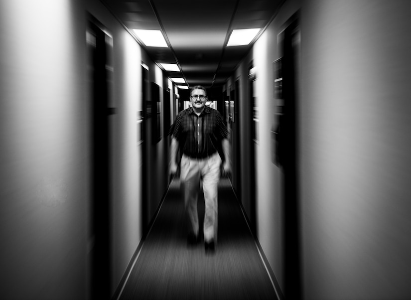 Jason Axberg, 628th Air Base Wing historian, walks down the hall to his office where he not only writes the current history, but also researches prior histories April 22, 2014. (U.S. Air Force photo/ Senior Airman Dennis Sloan)