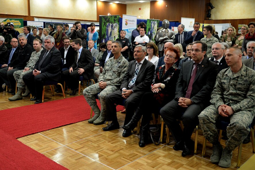 Base leadership, honorary commanders, civic leaders, community members and Airmen attend the opening ceremony for the 10th Annual Explore the Eifel Info and Adventure Fair at Club Eifel on Spangdahlem Air Base, Germany, April 24, 2014. The event featured more than 250 participants and 80 booths offering tours, info, hikes and more. (U.S. Air Force photo by Senior Airman Alexis Siekert/Released)