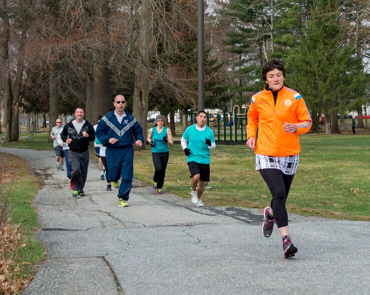 HANSCOM AIR FORCE BASE, Mass. – Linda Ambard, 66th Air Base Group community support coordinator, leads a pack of runners through Castle Park during the Sexual Assault Awareness Month 5k fun run, April 18. Top finishers in the male category were Kyle Larson, 17:32; Shannon Taylor, 19:15; Danny Hugh, 23:05. The top female finishers were Linda Ambard, 25:13; Vanessa Urban, 27:44 and Christine Jeffers, 27:46. (U.S. Air Force photo by Rick Berry)
