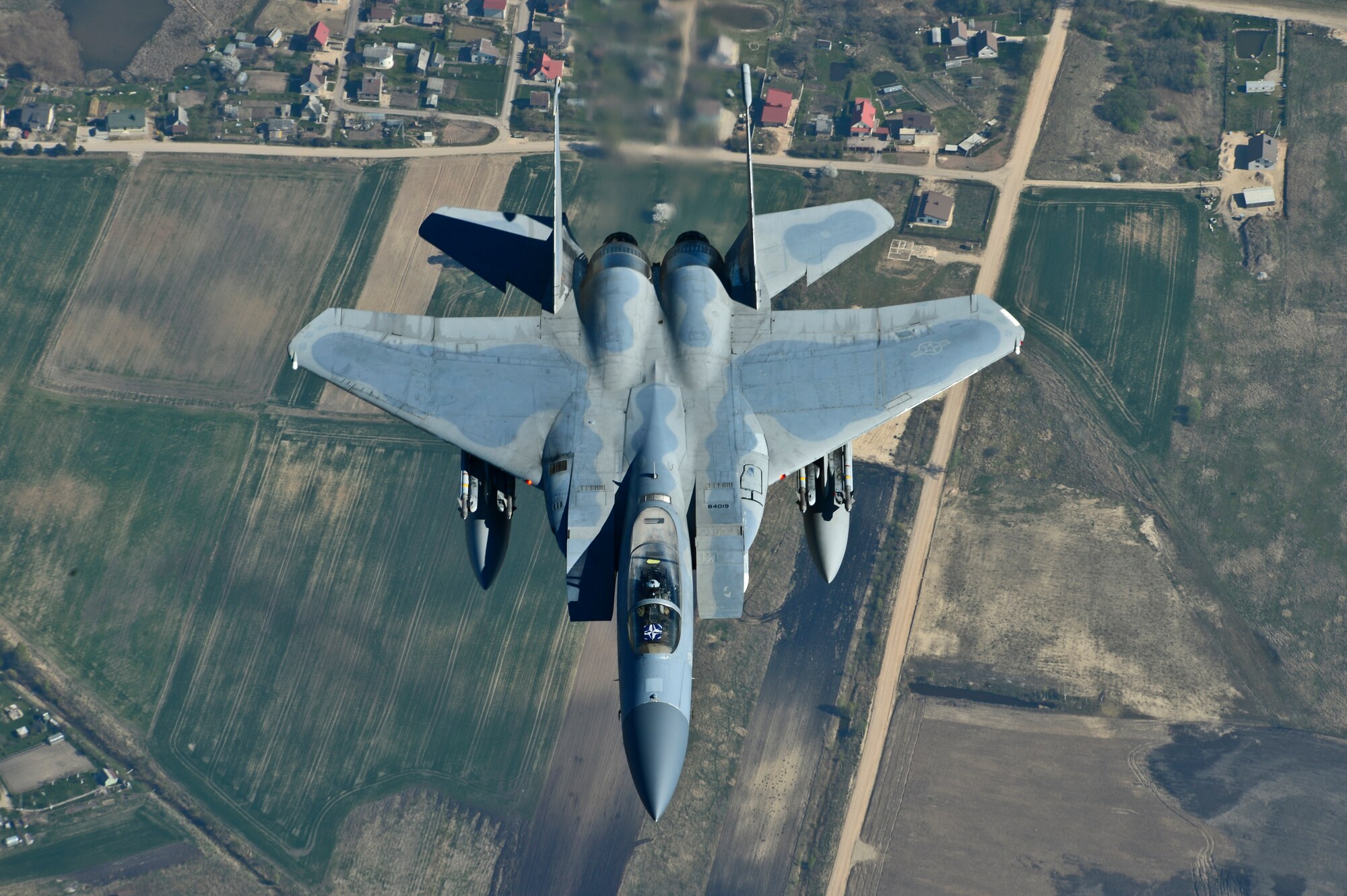 Maj. Barak Amundson, 493rd Expeditionary Fighter Squadron pilot, flies over Lithuania during a training mission with the Lithuanian air force April 23, 2014. The 48th Air Expeditionary Group has been conducting the Baltic Air Policing mission here since January and will be handing over the mission to the Polish air force at the beginning of May. (U.S. Air Force photo by Airman 1st Class Dana J. Butler/Released)