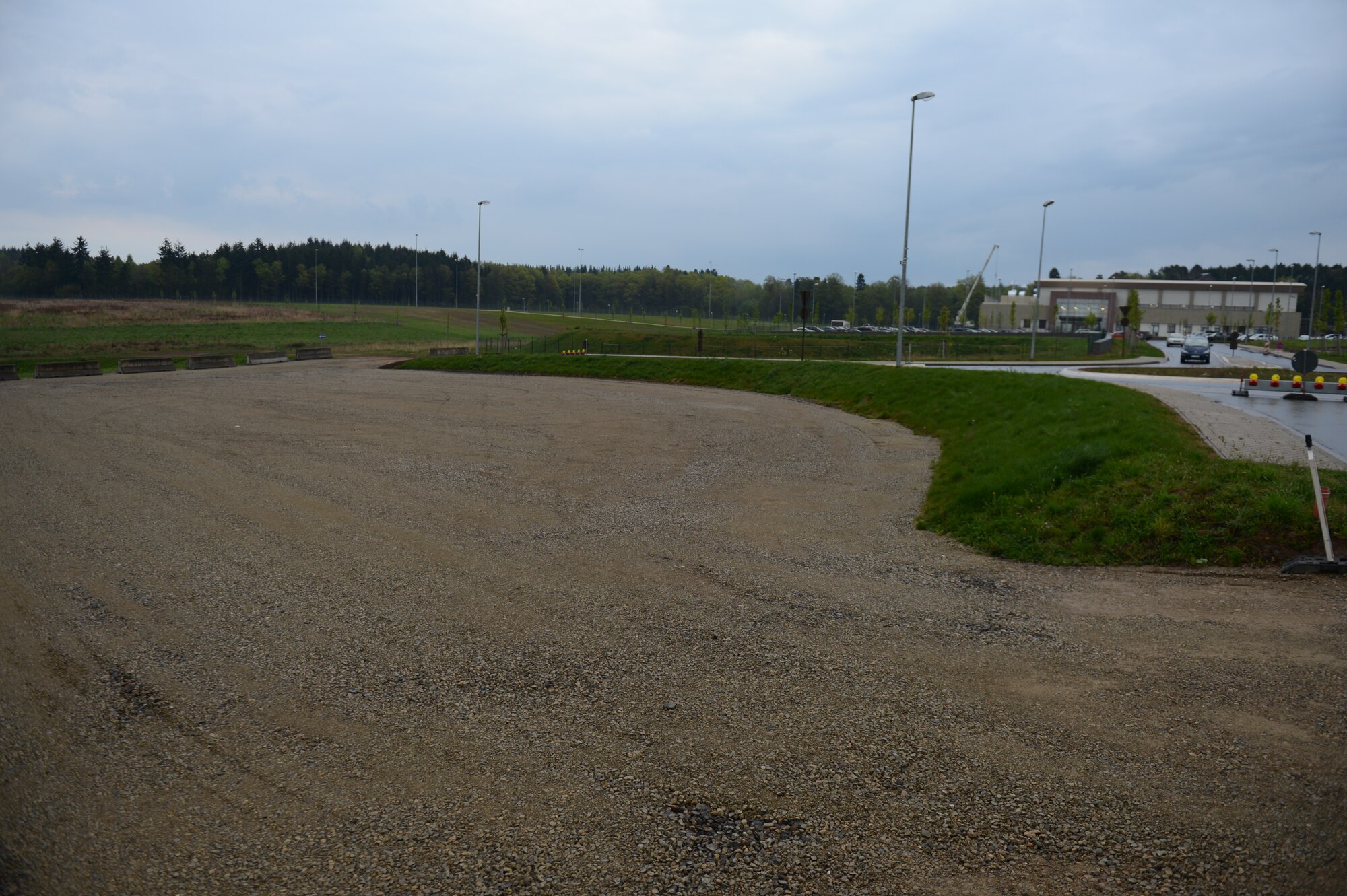 The temporary overflow parking area resides close to the Eifel Powerhaus at Spangdahlem Air Base, Germany, April 24, 2014. Thirteen Airmen spent 1,440 hours hauling and placing nearly 3,000 tons of assorted fill and finish material to create the parking area. (U.S. Air Force photo by Senior Airman Gustavo Castillo/Released)