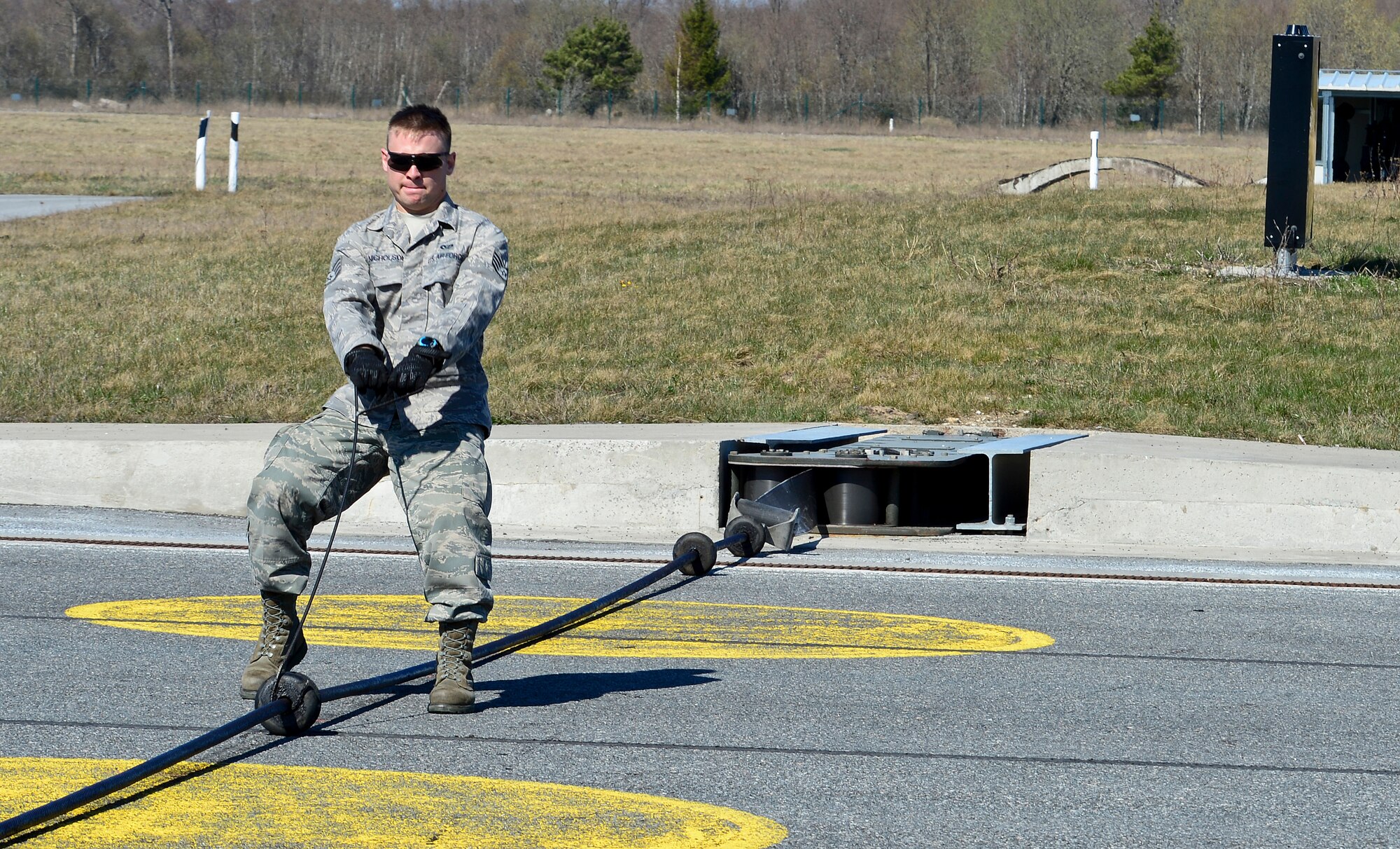Staff Sgt. Josh Nicholson, 48th Air Expeditionary Group aircraft arresting systems craftsman, spaces support discs after conducting a certification barrier engagement at Amari Air Base, Estonia, April 22, 2014. Members of the 48th AEG recently took a trip to Amari AB to engage and certify the aircraft arresting system, taking a critical step toward validating the new NATO Forward Operating Base. (U.S. Air Force photo by Airman 1st Class Dana J. Butler/Released)