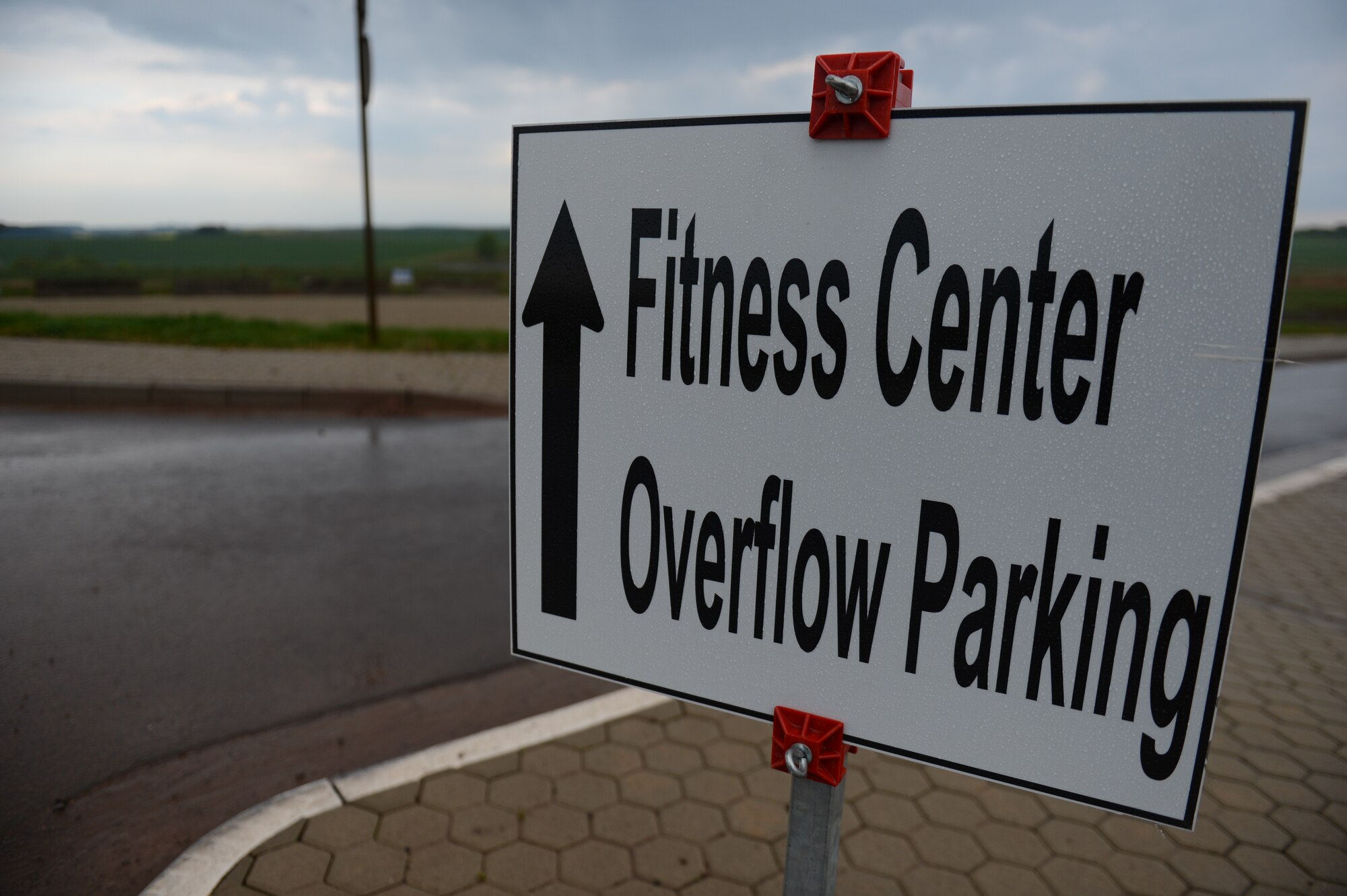 A sign directs traffic to the temporary overflow parking area near the Eifel Powerhaus at Spangdahlem Air Base, Germany, April 24, 2014. Without this overflow parking, vehicles would park on the side of the road resulting in a safety hazard. (U.S. Air Force photo by Senior Airman Gustavo Castillo/Released)