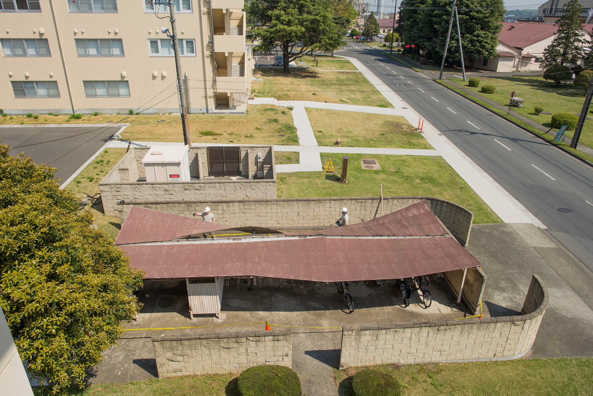 Airmen with the 374th Civil Engineer Squadron structures shop remove a damaged roof from a dormitory bicycle lot at Yokota Air Base, Japan, April 24, 2014. The roof, which was damaged in the winter during heavy snowfall, was removed to prevent possible injury and allow dormitory residents access to their bicycle lot. (U.S. Air Force photo by Staff Sgt. Cody H. Ramirez/Released)
