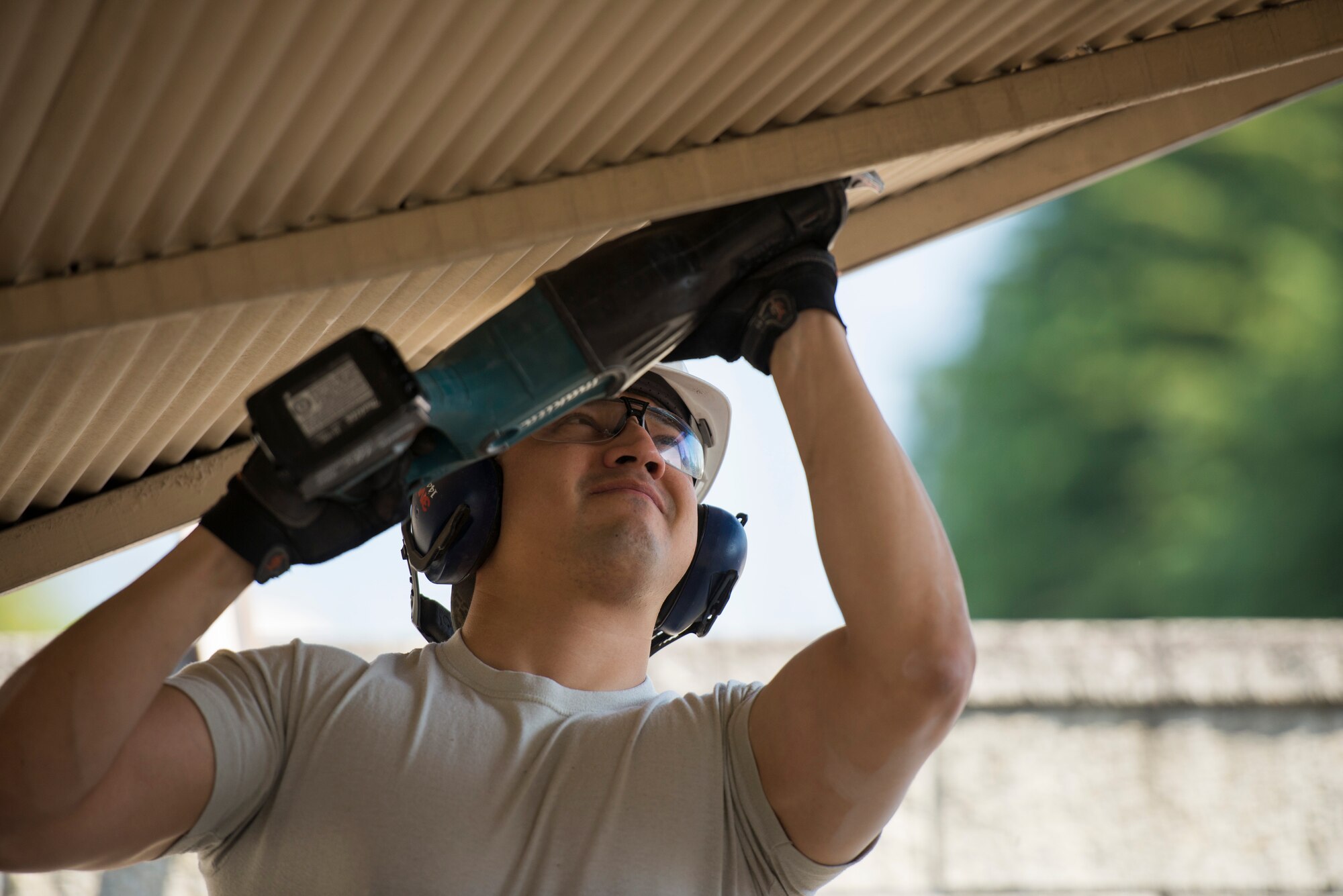Staff Sgt. Daniel Vera-Erazo, 374th Civil Engineer Squadron structures craftsman, cuts a bolt to remove a damaged roof at Yokota Air Base, Japan, April 24, 2014. The roof, which was damaged during the winter’s heavy snowfall, was removed to prevent possible injury and allow dormitory residents access to their bicycle lot. (U.S. Air Force photo by Staff Sgt. Cody H. Ramirez/Released)