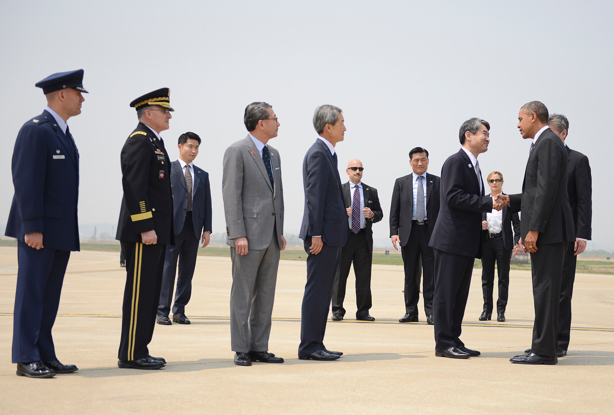President Barack Obama greets Republic of Korea Minister of Foreign Affairs Cho Tae-Young upon his arrival at Osan Air Base, Republic of Korea, April 25, 2014. Other members in attendence to welcome Obama were, right to left,  ROK ambassador to the United States Ambassador Ho Young Ahn, ROK Chief of Protocol Choe Jong-Hyun, U.S. Forces Korea Commander Gen. Curtis Scaparrotti, and 51st Fighter Wing Commander Col. Brook Leonard. This marks Obama's fifth trip to Asia as he focuses on major priorities in the Asia-Pacific region: modernizing alliances; supporting democratic development; advancing the Trans-Pacific Partnership and commercial ties; investing in regional institutions; and deepening cultural and people-to-people ties. (U.S. Air Force photo/Tech. Sgt. Micky M. Bazaldua)
