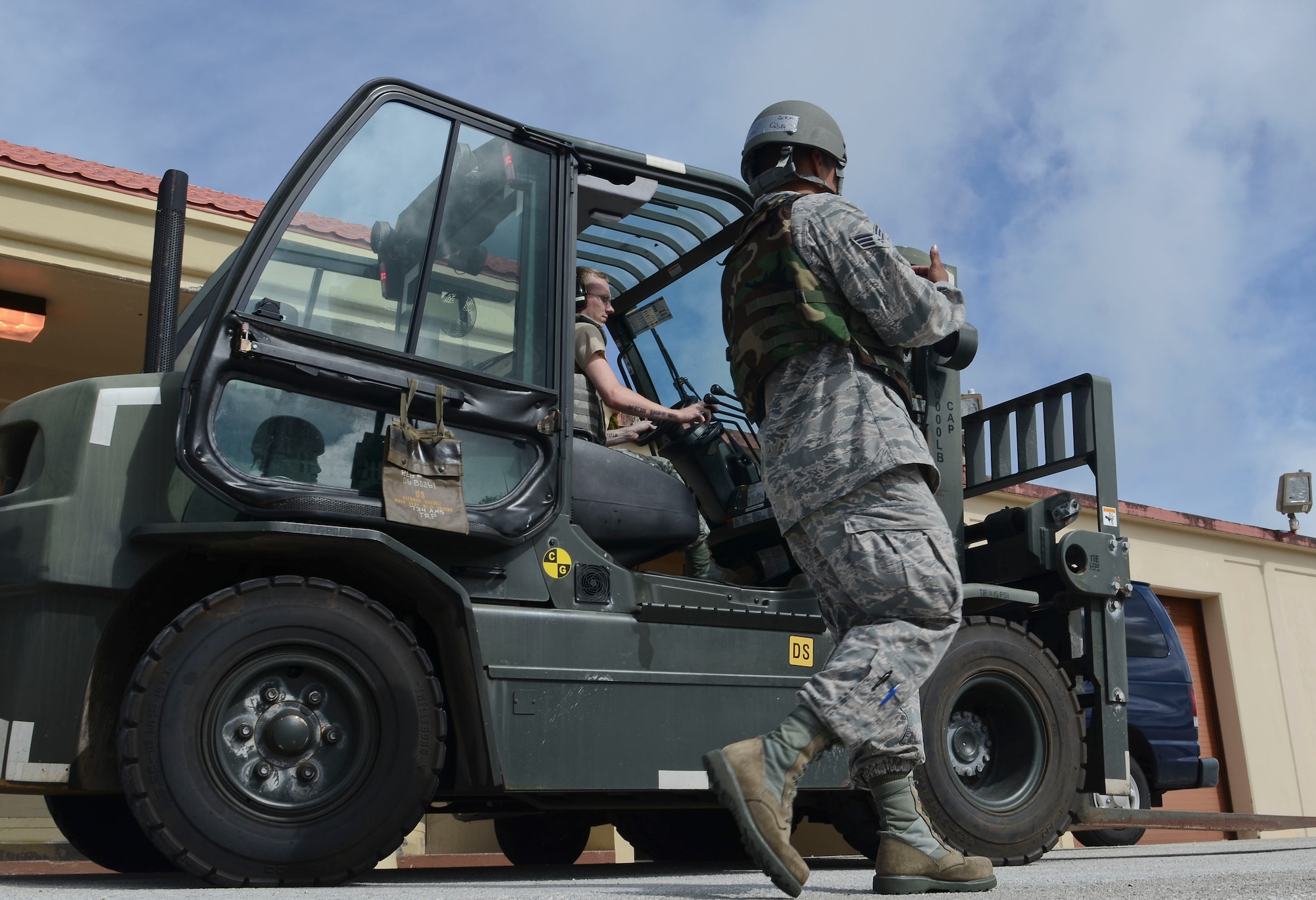 734th Air Mobility Squadron passenger service agents Senior Airman Tomas Cubilla and Airman 1st Class Adam McAteer operate a forklift April 16, 2014 during an operational readiness exercise on Andersen Air Force Base, Guam. The 36th Wing exercises regularly to ensure Airmen and the base populace are trained and ready to respond quickly and accurately in the event of a crisis. (U.S. Air Force photo by Airman 1st Class Emily A. Bradley/Released)