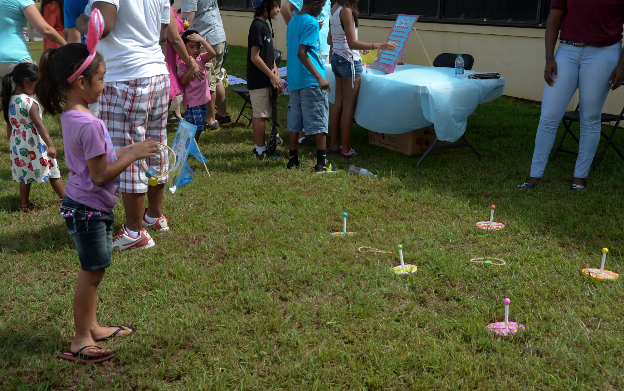 A Team Andersen child plays ring toss during an Easter celebration April 19, 2014, on Andersen Air Force Base, Guam. The Base Exchange and Andersen Network 5/6 sponsored the event which consisted of an Easter Egg hunt, family games, face painting and a bounce house. (U.S. Air Force photo by Airman 1st Class Amanda Morris/Released)