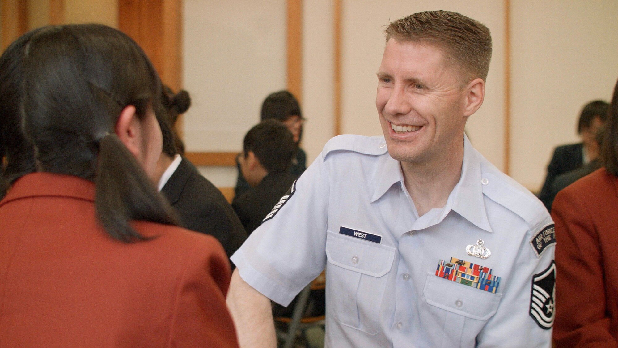 IBARAKI, Japan—Master Sgt. Dwight Wiest, Band of the Pacific-Asia saxophonist, talks with a student, during an interactive group activity at Chigakukan Secondary School, Mito City, Ibaraki, Japan, April 16, 2014. The result was a chance for students to practice their English as well as learn about the Air Force members. The activity took place following a band performance for students and teachers. (U.S. Air Force photo by Staff Sgt. Geoffrey Fisher)