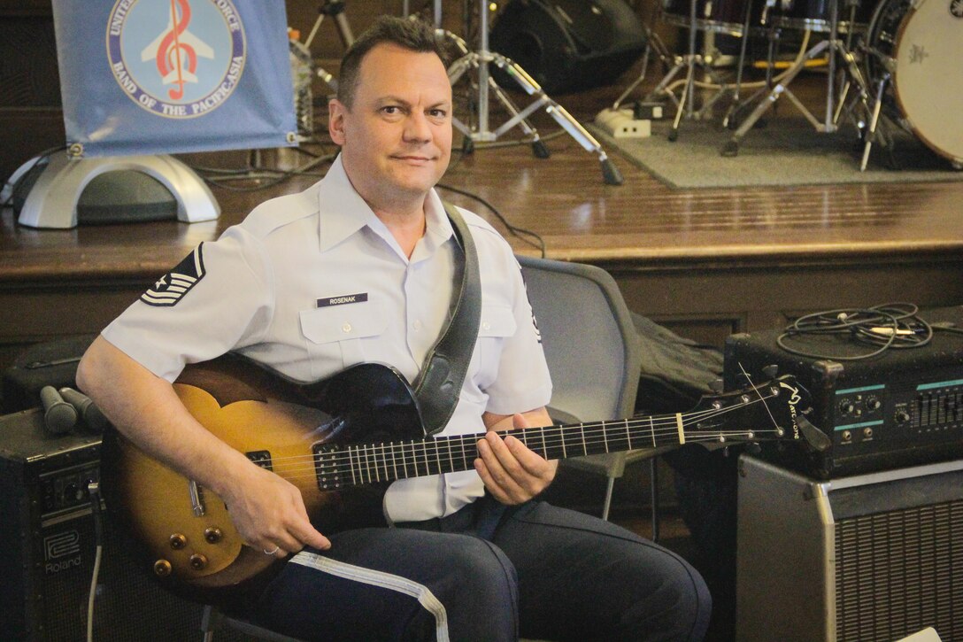 TOCHIGI, Japan—MSgt Gary Rosenak, Band of the Pacific-Asia guitarist, poses with Pacific Showcase, Band of the Pacific-Asia jazz ensemble, during a performance at Utsunomiya University, Utsunomiya City, Tochigi, Japan, April 14, 2014. The event included an interactive joint performance with the University’s own, “New Motley Orchestra.”  (U.S. Air Force photo by Staff Sgt. Geoffrey Fisher)