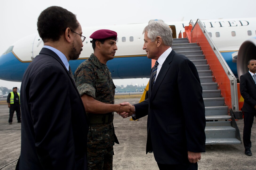 U.S. Defense Chuck Hagel shakes hands with Guatemalan Defense Minister Maj. Gen. Manuel Lopez Ambrosio as Charge d'Affaires Bruce Williamson from the U.S. Embassy looks on upon Hagel's arrival in Guatemala City, April 24, 2014. Hagel met with the Guatemalan president, defense counterparts and U.S. troops conducting exercises in the area during his visit.