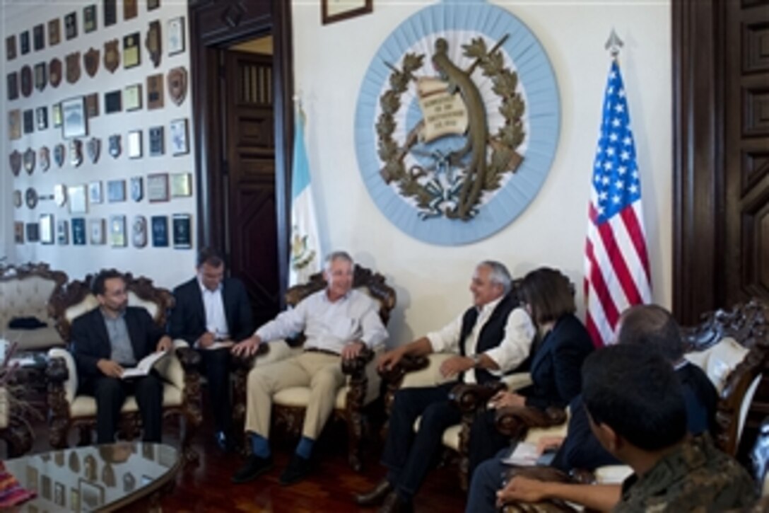 U.S. Defense Secretary Chuck Hagel, left, shares a light moment with Guatemalan President Otto Perez Molina in Guatemala City, April 25, 2014. Hagel also met with defense counterparts and U.S. troops conducting exercises in the area during his visit.