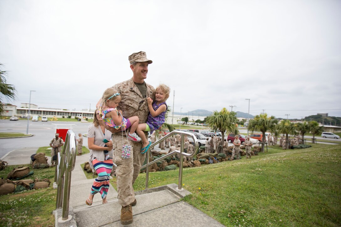 Staff Sgt. Benjamin D. Jacobsen, a team leader with the Maritime Raid Force, 31st Marine Expeditionary Unit, and a native of Rockport, Texas, carries his children up the steps of the 31st MEU Headquarters after returning from the annual Spring Patrol here, April 24. During the patrol, the 31st MEU participated in the largest iteration of Exercise SSang Yong in the history of the bilateral event. The 31st MEU led the 3d Marine Expeditionary Brigade’s ground forces as Regimental Landing Team 31 during a simulated forceful entry in the Republic of Korea. The combat exercise was conducted alongside ROK Marine Corps and Navy forces, as well as soldiers of the Royal Australian Army to make a combined force of more than 13,000.