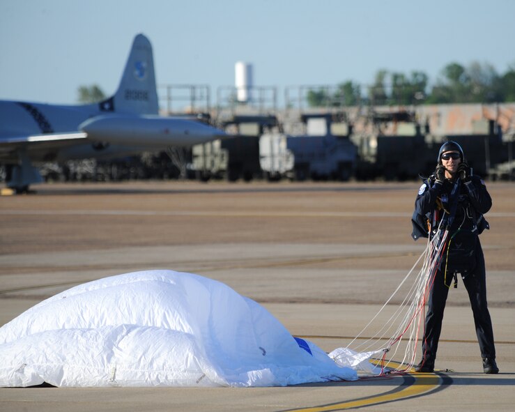 A U.S. Air Force Sky Diving Team jumper removes his gear after a successful jump during the Defenders of Liberty Air Show on Barksdale Air Force Base, La., April 25, 2014. Members of the team serve primarily as jump masters and instructors for this course, devoting most of their time to teaching students about parachuting and training them to make unassisted freefall skydives. (U.S. Air Force photo/Senior Airman Benjamin Gonsier)