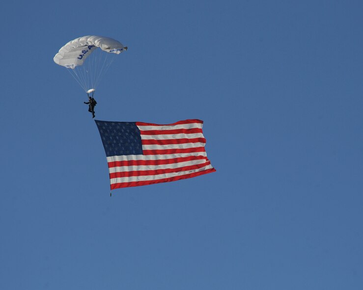 A U.S. Air Force Sky Diving Team jumper displays the American flag during the Defenders of Liberty Air Show on Barksdale Air Force Base, La., April 25, 2014. The Sky Diving Team, Wings of Blue, was established in 1962, but did not receive U.S. Air Force Academy club status until 1964. (U.S. Air Force photo/Senior Airman Benjamin Gonsier)