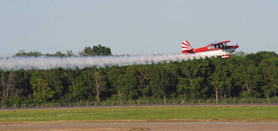 A Super Decathlon, piloted by Gary Boucher, flies before a crowd on Barksdale Air Force Base, La., April 25, 2014. The annual base air show provides the 2nd Bomb Wing an opportunity to showcase the Air Force mission and to say thanks to the Shreveport-Bossier community for generously supporting Barksdale Air Force Base. (U.S. Air Force photo/Senior Airman Benjamin Gonsier)