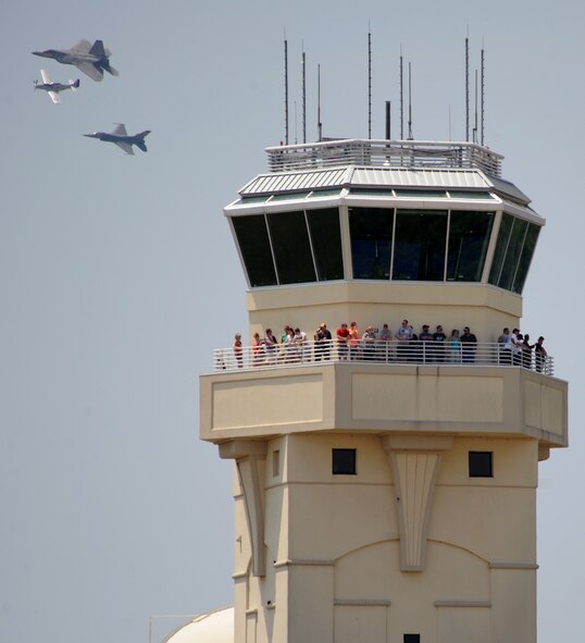 An F-22 Raptor, P-51 Mustang and F-16 Fighting Falcon pass the Barksdale air traffic control tower during the Defenders of Liberty Air Show on Barksdale Air Force Base, La., April 26, 2014. The U.S. Air Force Heritage Flight program presents the evolution of air power by flying today's state-of-the-art fighter aircraft in close formation with vintage fighter aircraft. (U.S. Air Force photo/Senior Airman Benjamin Gonsier)
