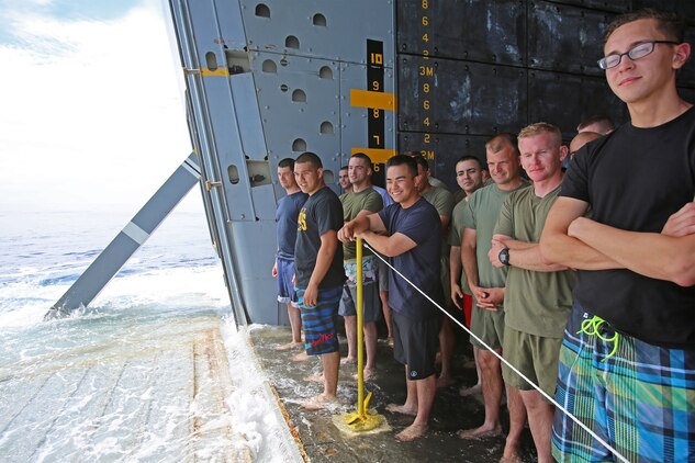 Marines and sailors with Special Purpose Marine Air Ground Task Force Association of Southeast Asian Nations participate in a Swim Call - allowing them to swim in a small area behind the ship, secured by lifeboats and a safety line aboard amphibious transport dock ship USS Anchorage (LPD 23), April 11, 2014. Swimming in the sea, more than a thousand miles away from land, provided the Marines and sailors with a physically intensive but unique experience. The event was one of many recreational events held with SPMAGTF-ASEAN to relieve stress and build unit cohesion. SPMAGTF-ASEAN, aboard Anchorage, recently completed a mission to support U.S. Secretary of Defense Chuck Hagel during a press conference with delegates and media personnel from the ASEAN in Hawaii, April 1-4, 2014 and is currently at sea conducting further training and maintenance on equipment.