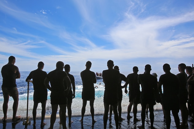 Marines and sailors with Special Purpose Marine Air Ground Task Force Association of Southeast Asian Nations participate in a Swim Call - allowing them to swim in a small area behind the ship, secured by lifeboats and a safety line aboard amphibious transport dock ship USS Anchorage (LPD 23), April 11, 2014. Swimming in the sea, more than a thousand miles away from land, provided the Marines and sailors with a physically intensive but unique experience. The event was one of many recreational events held with SPMAGTF-ASEAN to relieve stress and build unit cohesion. SPMAGTF-ASEAN, aboard Anchorage, recently completed a mission to support U.S. Secretary of Defense Chuck Hagel during a press conference with delegates and media personnel from the ASEAN in Hawaii, April 1-4, 2014 and is currently at sea conducting further training and maintenance on equipment. 