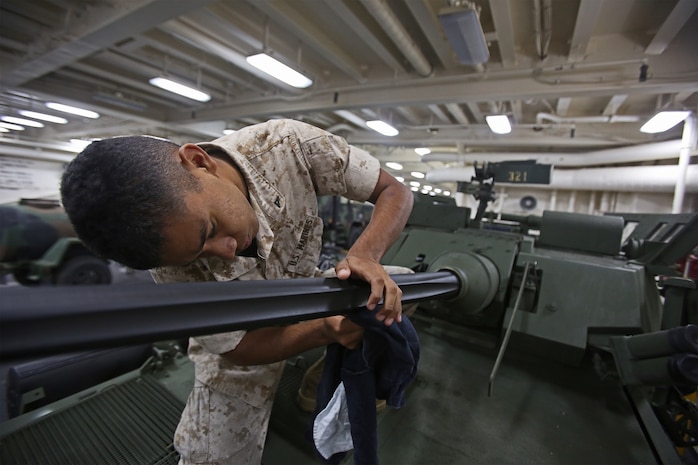 Lance Cpl. Jose Arredondo, a light armored vehicle crewman with 1st Light Armored Reconnaissance Battalion, 1st Marine Division, cleans the barrel of a 25mm Bushmaster chain gun while part of Special Purpose Marine Air Ground Task Force ASEAN, aboard amphibious transport dock ship USS Anchorage (LPD-23), April 15, 2014. As part of SPMAGTF-ASEAN, 1st LAR showcased their territorial defense capabilities alongside units with 1st MLG on their mission to support the U.S. Secretary of Defense Chuck Hagel, during the Association of Southeast Asian Nations press conference in Hawaii, April 1-4, 2014. SPFMAGTF-ASEAN conducted further training at sea starting April 7, 2014. Arredondo is from Reno, Nevada. 