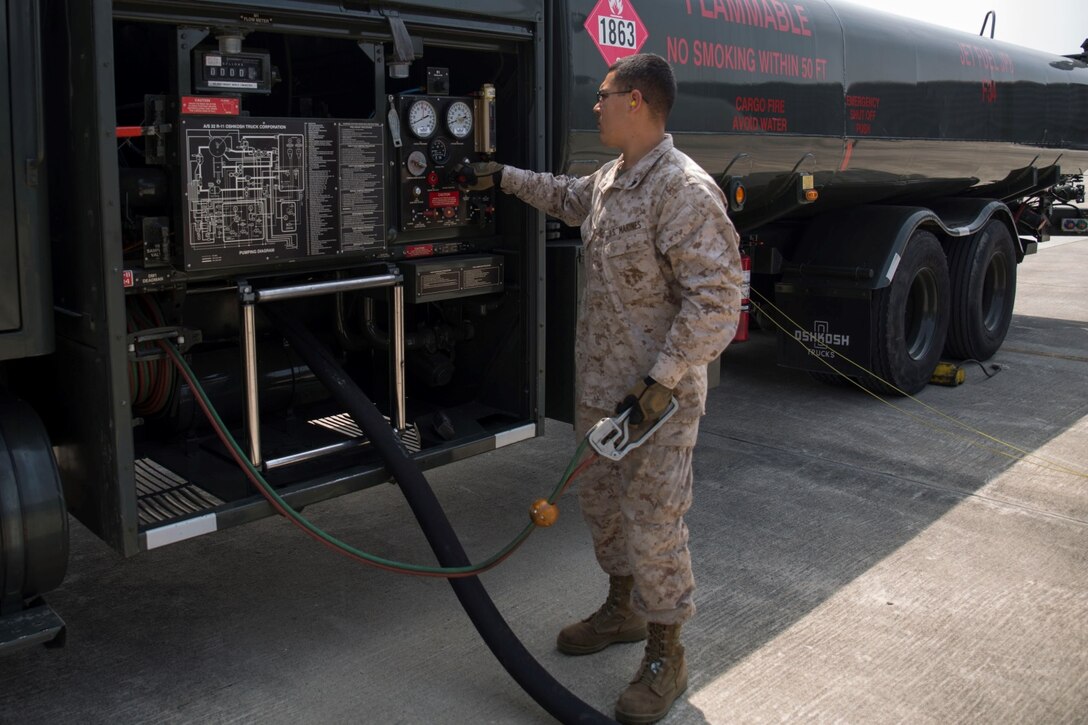 Cpl. Luis Lara, a Semitrailer refueler operator with Marine Wing Support Squadron 171, observes pressure valves and fuel levels during a refueling aboard Gwangju Air Base, Republic of Korea, as part of Exercise Max Thunder 14-1, April 16, 2014. Lara is one of five Marines with MWSS-171 deployed to assist with the refueling of military aircraft during the exercise.    