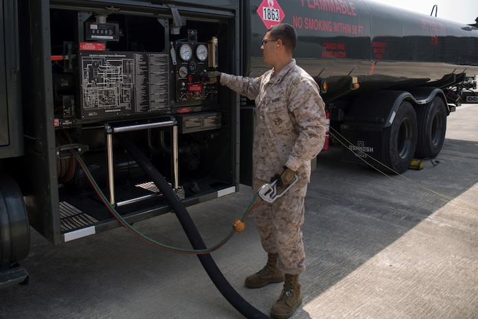 Cpl. Luis Lara, a Semitrailer refueler operator with Marine Wing Support Squadron 171, observes pressure valves and fuel levels during a refueling aboard Gwangju Air Base, Republic of Korea, as part of Exercise Max Thunder 14-1, April 16, 2014. Lara is one of five Marines with MWSS-171 deployed to assist with the refueling of military aircraft during the exercise.    