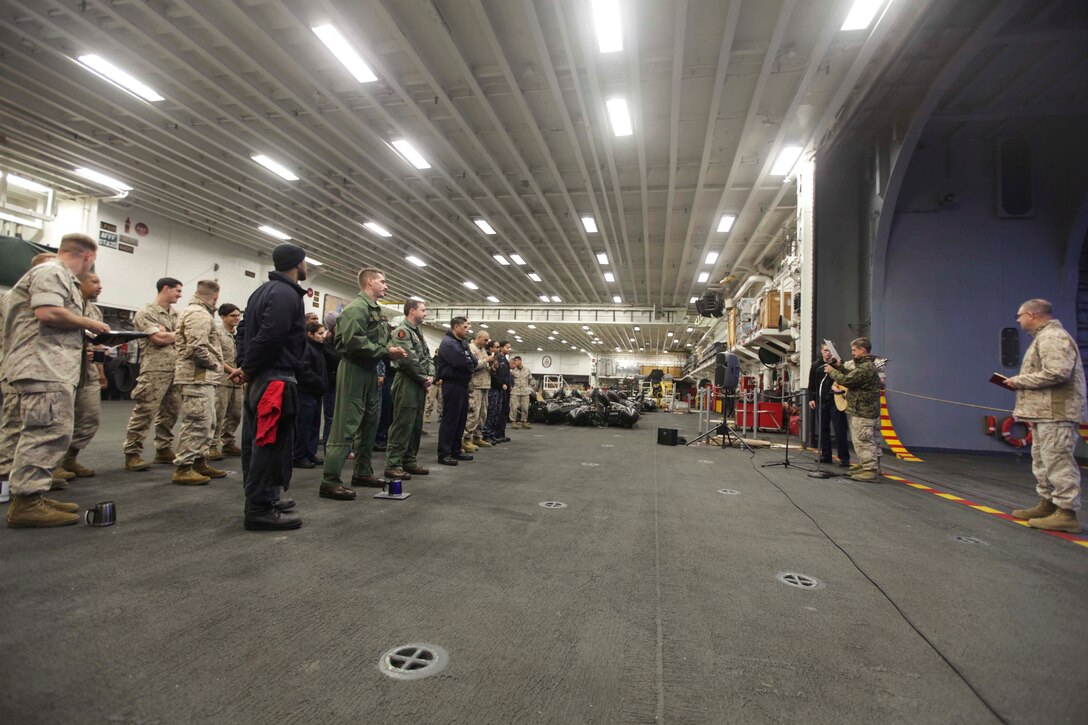 Services members with the 31st Marine Expeditionary Unit and Amphibious Squadron 11 attend Easter Sunday sunrise service during Holy Week in the hangar bay of the USS Bonhomme Richard (LHD 6) here, April 20. Holy Week is a week-long celebration leading up to Easter Sunday. The 31st MEU recently returned from participation in Exercise Ssang Yong ‘14 in the Republic of Korea and conducting theater security cooperation operations in the Asia-Pacific region. 