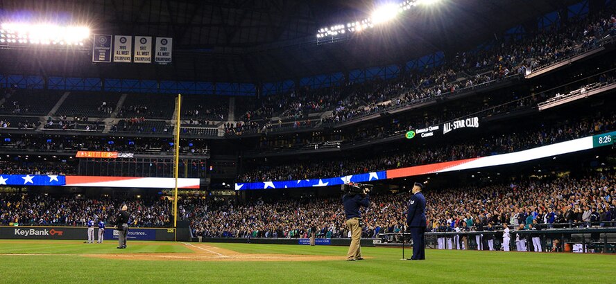 Tech. Sgt. Freddie Garza, 446th Security Forces Squadron, sings "God Bless America" at Safeco Field in Seattle during the seventh inning of a Seattle Mariners vs. Texas Ranger baseball game. Garza has been both a Seattle Mariners fan and a singer since he was a kid and said he felt very honored for the opportunity to sing at the game. (U.S. Air Force Reserve Photo by Senior Airman Madelyn McCullough)