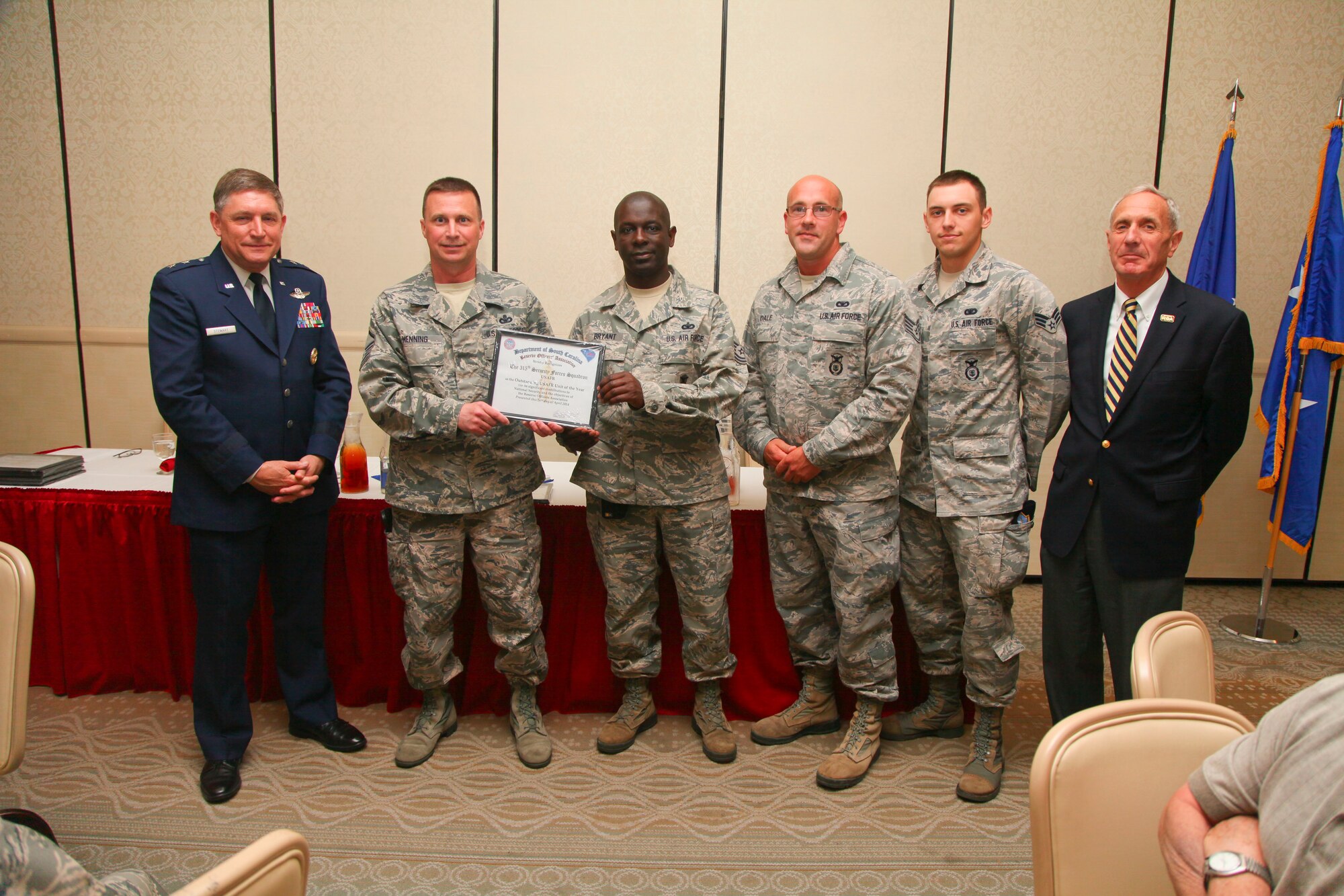 Master Sgt. Jerry Henning stands with Maj. Gen. James Stewart (left) and several members of the 315th Security Forces Squadron from Joint Base Charleston, S.C., yesterday at the base club here at Joint Base Charleston, S.C. The ROA awards luncheon recognized the accomplishments of various South Carolina reserve organizations and ROA members. (U.S. Air Force photo by Staff Sgt. Rashard Coaxum/released)