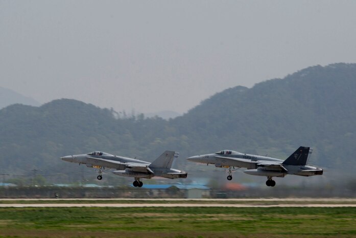 Two F/A-18 hornet aircraft with Marine Fighter Attack Squadron 122 take off from Gwangju Air Base April 21, 2014, as part of Exercise Max Thunder 14-1. As part of MT 14-1, VMFA-122, stationed out of Beaufort, S.C., is providing eight F/A-18 hornet aircraft to support both U.S. and ROK forces in different scenarios throughout the exercise.