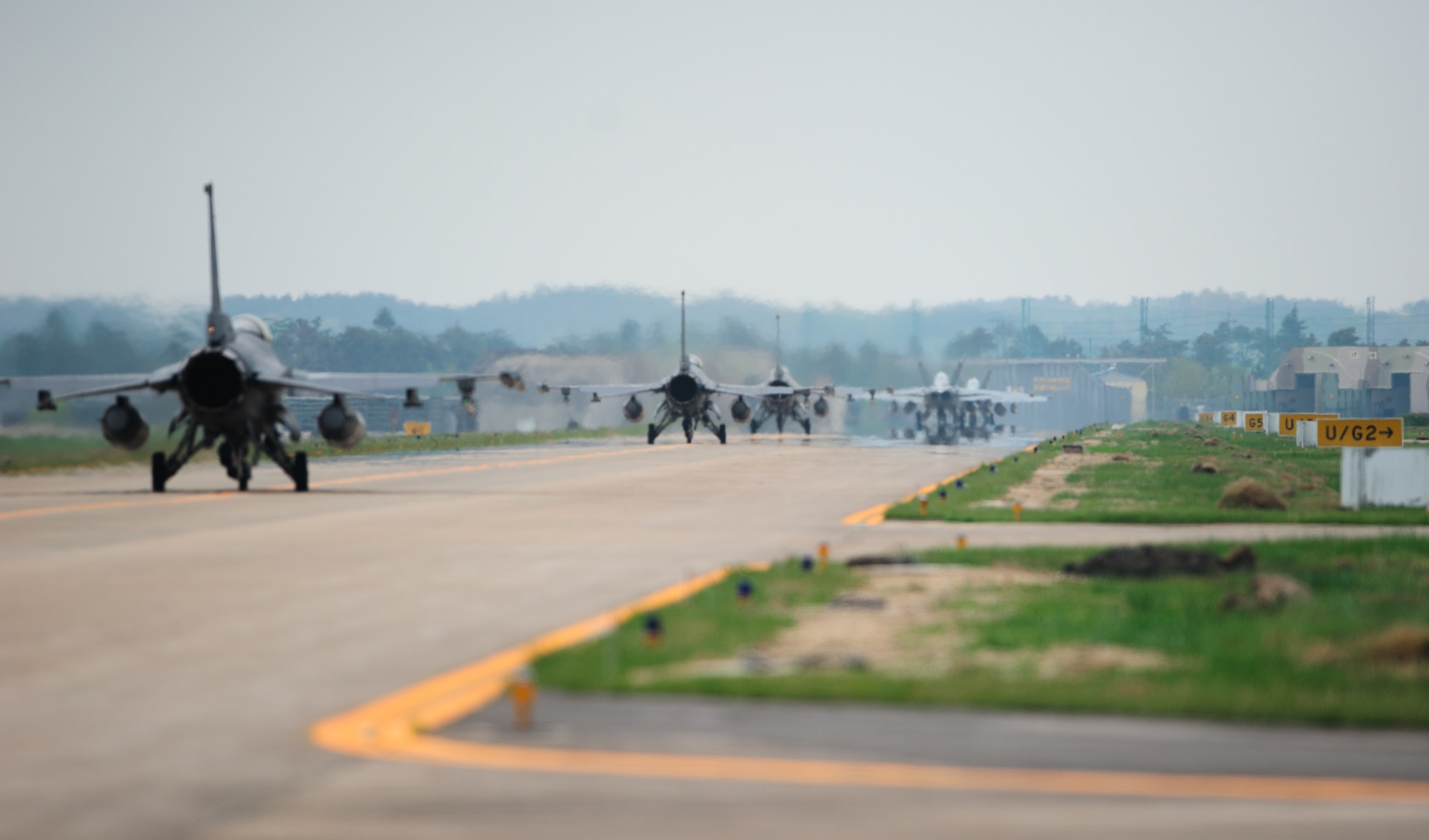 U.S. Navy, Marine Corps and Air Force pilots taxi towards the runway to begin a joint sortie during the 12th Max Thunder April 22, 2014, at Gwangju Air Base, Republic of Korea. The two-week exercise is the air component-led portion of Exercise Foal Eagle and trains both ROK and U.S. Airmen on aerial training. (U.S. Air Force photo by Senior Airman Armando A. Schwier-Morales)