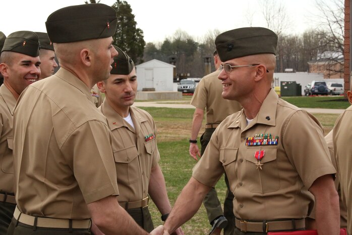 Fellow warrant officers congratulate Warrant Officer Jeremy Barone after being awarded the Bronze Star Medal with combat distinguishing device at The Basic School aboard Marine Corps Base Quantico on April 11, 2014. Barone received the award for heroic service while serving as the first sergeant with Co. F, 2nd Bn., 8th Marines, 2nd Marine Expeditionary Force Headquarters Group Forward, from April- October 2013, while deployed to Afghanistan during Operation Enduring Freedom.