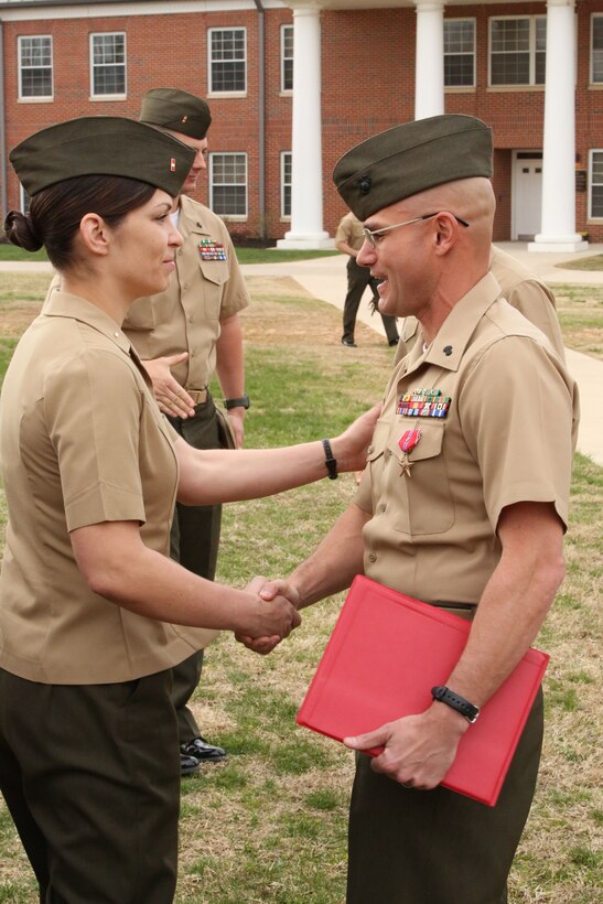 Fellow warrant officers congratulate Warrant Officer Jeremy Barone after being awarded the Bronze Star Medal with combat distinguishing device at The Basic School aboard Marine Corps Base Quantico on April 11, 2014. Barone received the award for heroic service while serving as the first sergeant with Co. F, 2nd Bn., 8th Marines, 2nd Marine Expeditionary Force Headquarters Group Forward, from April- October 2013, while deployed to Afghanistan during Operation Enduring Freedom.