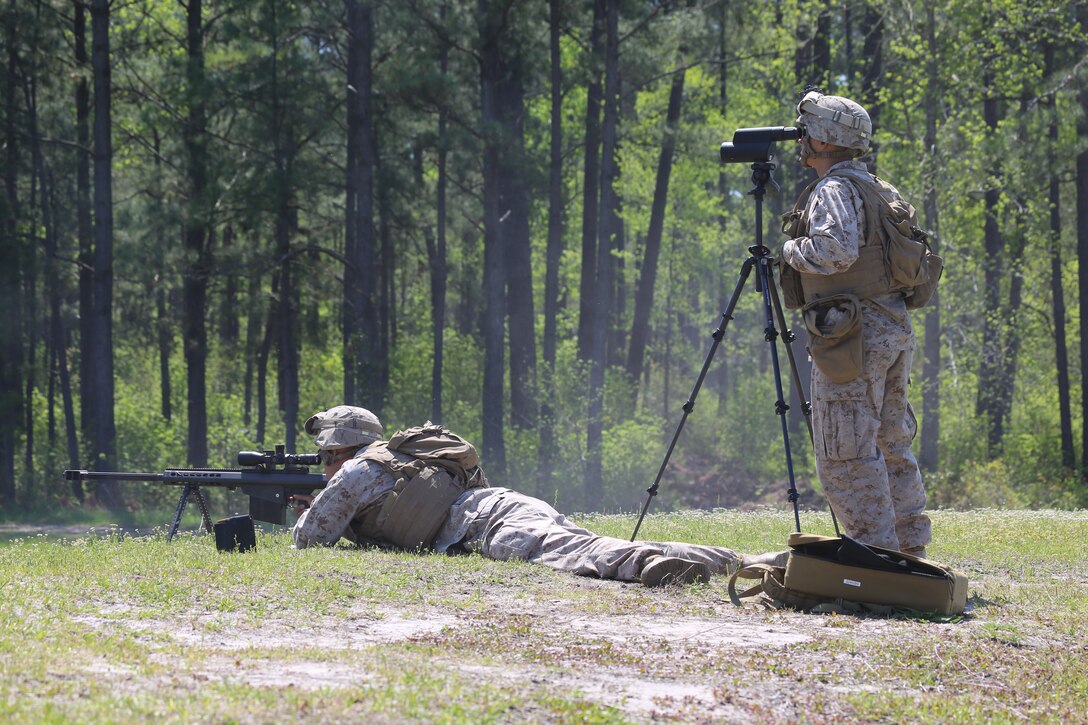 Lance Cpl Luis Beltran, a rifleman with Delta Company, 2nd Light Armored Reconnaissance Battalion, 2nd Marine Division, fires the M107 .50 Caliber Special Application Scoped Rifle, while LCpl Kevin Cruzvazquez, a rifleman also with Delta Company, observes where the rounds impact on designated targets at a range aboard Marine Corps Base Camp Lejeune, NC, April 23, 2014. This is a part of training conducted within the battalion that qualified designated Marines to safely, efficiently and effectively employ the SASR in accordance to the commander's intent.