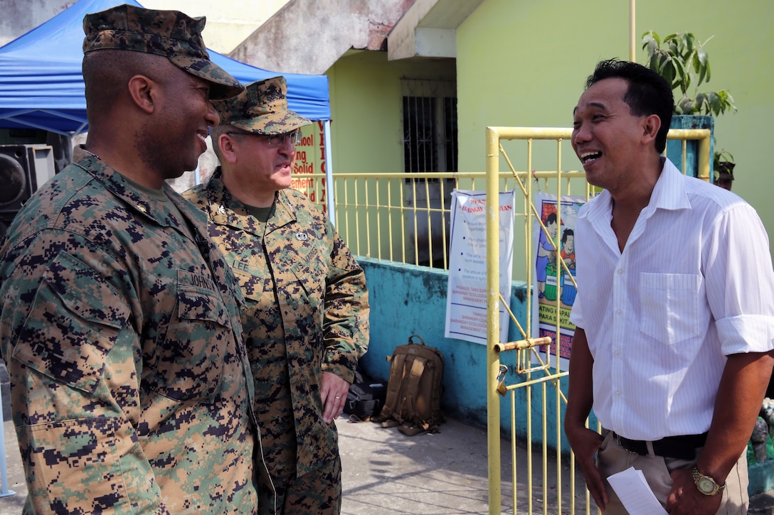 From left, U.S. Marine Corps Maj. Jason Johnson and Col. Curtis Lee meet with Ranulfo Abadesa, the principal of Tamaoyan Elementary School, before a groundbreaking ceremony at the school April 22, 2014, in Legazpi City, Philippines. The event marked the start of a renovation project at the school as part of exercise Balikatan 2014. Balikatan is an annual bilateral training exercise designed to increase interoperability between the Armed Forces of the Philippines and the U.S. military when responding to future natural disasters. (U.S. Marine Corps photo by Cpl. Kevin Crist/Released)