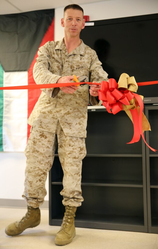 Lieutenant Col. Joel Schmidt, the battalion commander of 2nd Battalion, 2nd Marine Regiment, 2nd Marine Division, cuts a ribbon during a ribbon cutting ceremony held at the battalion command post aboard Marine Corps Base Camp Lejeune, NC, April 25, 2014. Also known as the NCO mess, the lounge is a place where the noncommissioned officers can participate in professional development through discussion, debate and mentorship in an environment that fosters critical thinking and education.