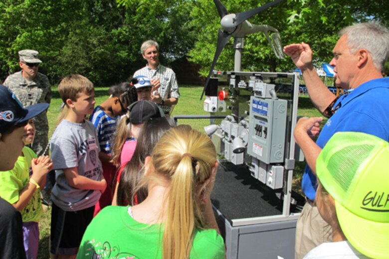 Jerry Adams, an instructor at Calhoun Community College’s Clean Energy Center, explains windmill technology using a wind turbine trainer during Thursday’s Earth Day event at the Path to Nature. The students are from Horizon Elementary School. 
