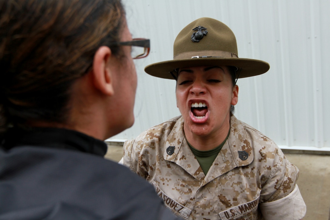 Staff Sgt. Cynthia Vasquez, a drill instructor, corrects an officer candidate during Recruiting Station Springfield’s and Recruiting Station Portsmouth’s officer candidate’s school prep weekend, on Camp Fogarty, April 26. The three day training events were designed to prepare the possible Marine Corps officers for Officer Candidates School in Quantico, Va. (Official Marine Corps Photo by Sgt. Richard Blumenstein)