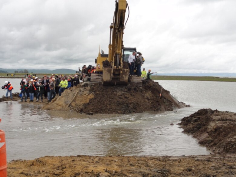 An excavator breaches the Hamilton Wetland Restoration Project outboard levee in Novato, Calif. on Friday, April 25, 2014.