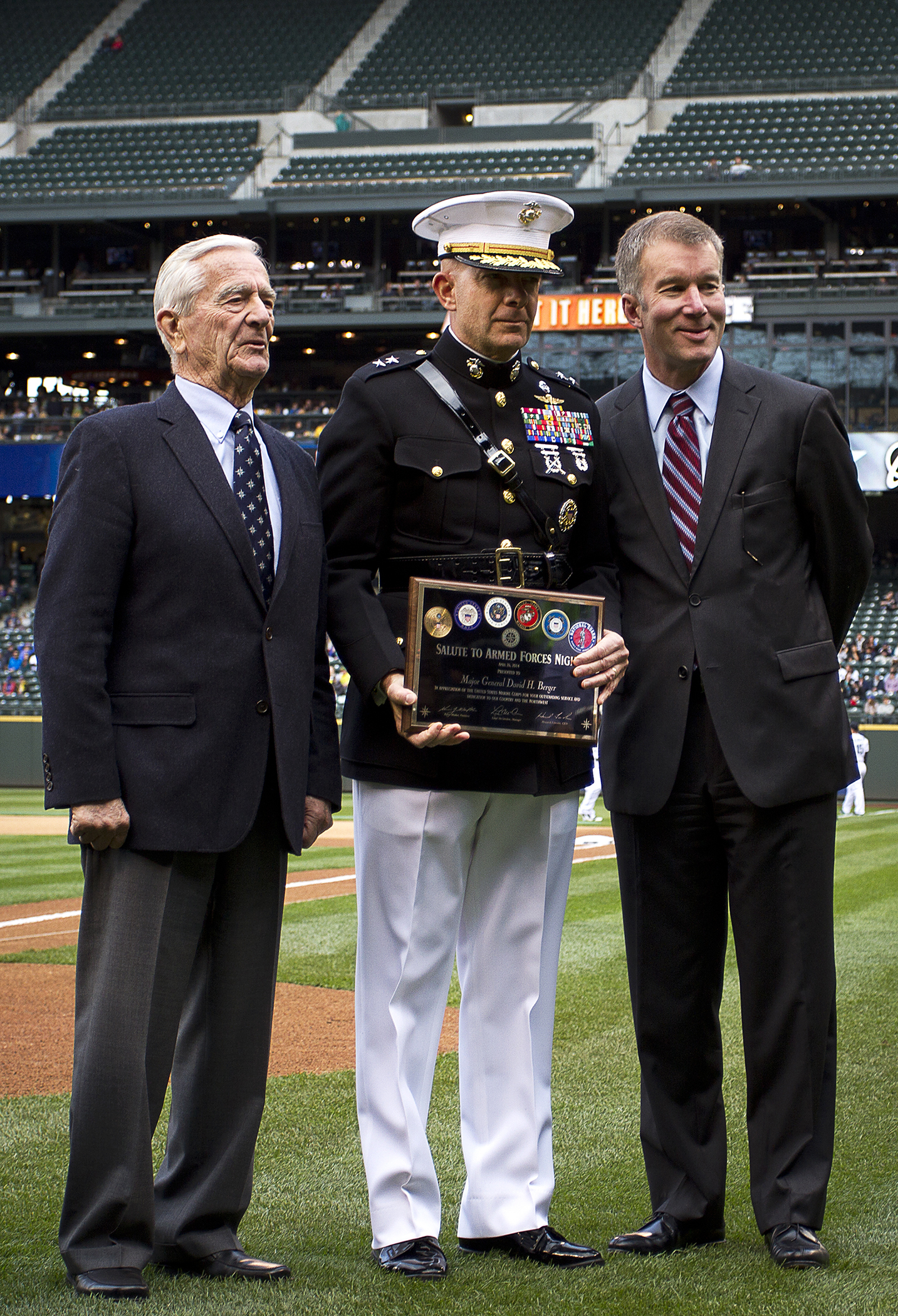 U.S. Marine Maj. Gen. David H. Berger, the commanding general of Marine Corps Air Ground Combat Center Twentynine Palms, Calif., poses with John Ellis (left), Chairman Emeritus, and Kevin Mather (right), President of the Seattle Mariners, during a Mariners’ Salute to Armed Forces Night at Safeco Field in Seattle, April 26, 2014. The event included the presentation of commemorative plaques to senior military leaders, a joint-service color guard and flag presentation, military band performances and ceremonial first pitches thrown out by members of each service. (U.S. Marine Corps photo by Sgt. Reece Lodder)