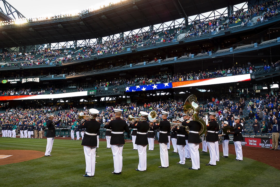 U.S. Marine Chief Warrant Officer 3 Edward Hayes (left), the officer in charge of the 1st Marine Division Band, directs the band as they perform the National Anthem before a Major League Baseball game between the Seattle Mariners and Texas Rangers at Safeco Field in Seattle, April 25, 2014. The 1st Marine Division Band is comprised of 50 U.S. Marine musicians and based at Marine Corps Base Camp Pendleton, Calif. Hayes, 48, is from Opa-lacka, Fla. (U.S. Marine Corps photo by Sgt. Reece Lodder)