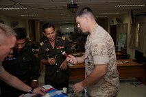 U.S. Navy Petty Officer 2nd Class Ryan W. Marczynski, right, shows an intraosseous catheter to Royal Cambodian Army Col. Mey Thun Nara during a practical application seminar March 20 as part of Cambodia Medical Exercise 14-1 in Phnom Penh, Cambodia. The catheter is used to initiate fluid resuscitation. The seminar is part of a weeklong medical subject-matter expert exchange focused on preparing and planning for humanitarian assistance and disaster relief efforts. During the seminar, participants learned how to properly use and improvise certain medical equipment, such as tourniquets, to better support first aid and triage procedures. Nara is a pharmacist and the deputy director of the Cambodia Ministry of Health. Marczynski is a corpsman with 3rd Medical Battalion, 3rd Marine Logistics Group, III Marine Expeditionary Force.


