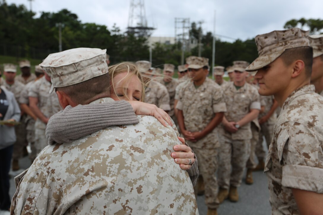 Danielle D. Campos hugs Sgt. Blake A. Wallace April 25 at Camp Hansen following an awards formation. Wallace and two other Marines used emergency medical techniques to save the life of Campos’ husband, Staff Sgt. Francisco E. Campos, who suffered a heart attack. “I don’t think I will ever be able to thank any of you enough for what you did,” said Campos’ wife. “When you saved him, you saved my life, too.” Wallace is a fire support man with Headquarters Battalion, 12th Marine Regiment, 3rd Marine Division, III Marine Expeditionary Force. (U.S. Marine Corps photo by Lance Cpl. Matt Myers/Released)