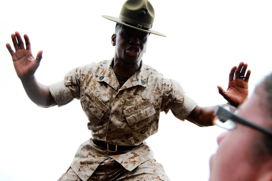Staff Sgt. Anthony Martinez, a drill instructor, corrects an officer candidate during Recruiting Station Springfield’s and Recruiting Station Portsmouth’s officer candidate’s school prep weekend, on Camp Fogarty, R.I., April 26, 2014. The three day training events were designed to prepare the possible Marine Corps officers for Officer Candidates School in Quantico, Va.