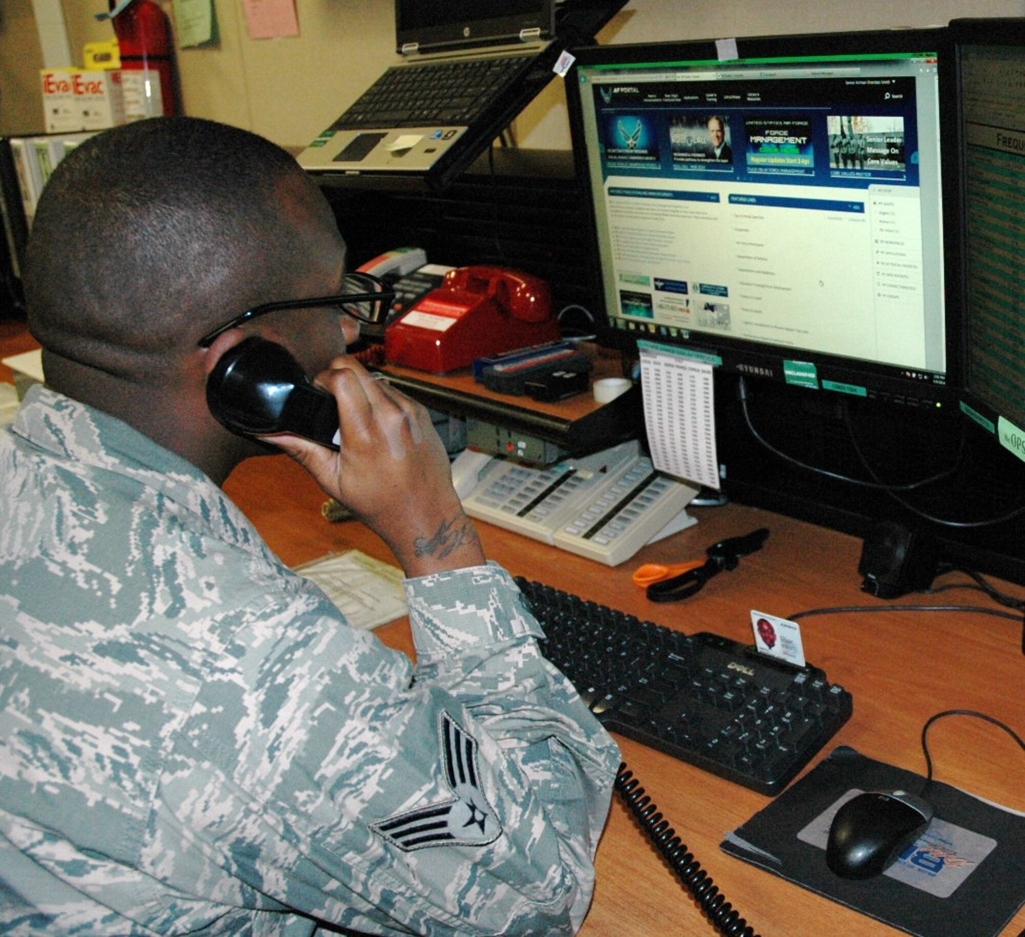 Senior Airman Sheridan Smith, command post emergency actions controller, receives a notification from the Base Defense Operations Center at Beale Air Force Base, Calif. As an active duty airman, Smith works side-by-side with Air Force reservists in a combined command post recently named AFRC's 2013 Large Command Post of the Year. (U.S. Air Force photo/Dana Lineback)