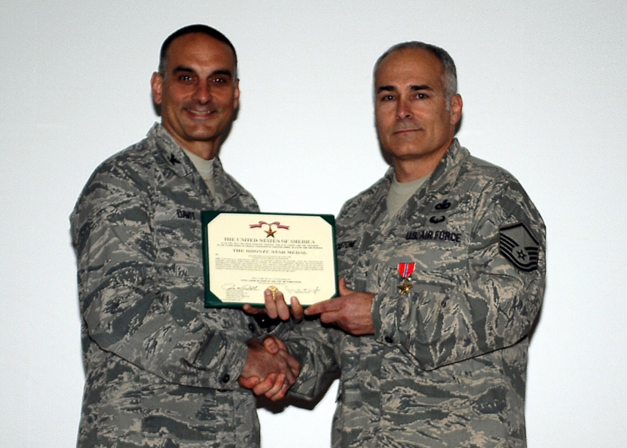 Col. Anthony Davit, 627th Air Base Group commander, presents the Bronze Star Medal to Master Sgt. Richard Blackstone, 627th Security Forces Squadron operations superintendent April 18, 2014, at Joint Base Lewis-McChord, Wash. Blackstone was awarded the medal for his actions during a firefight while deployed to Afghanistan. (Courtesy photo)