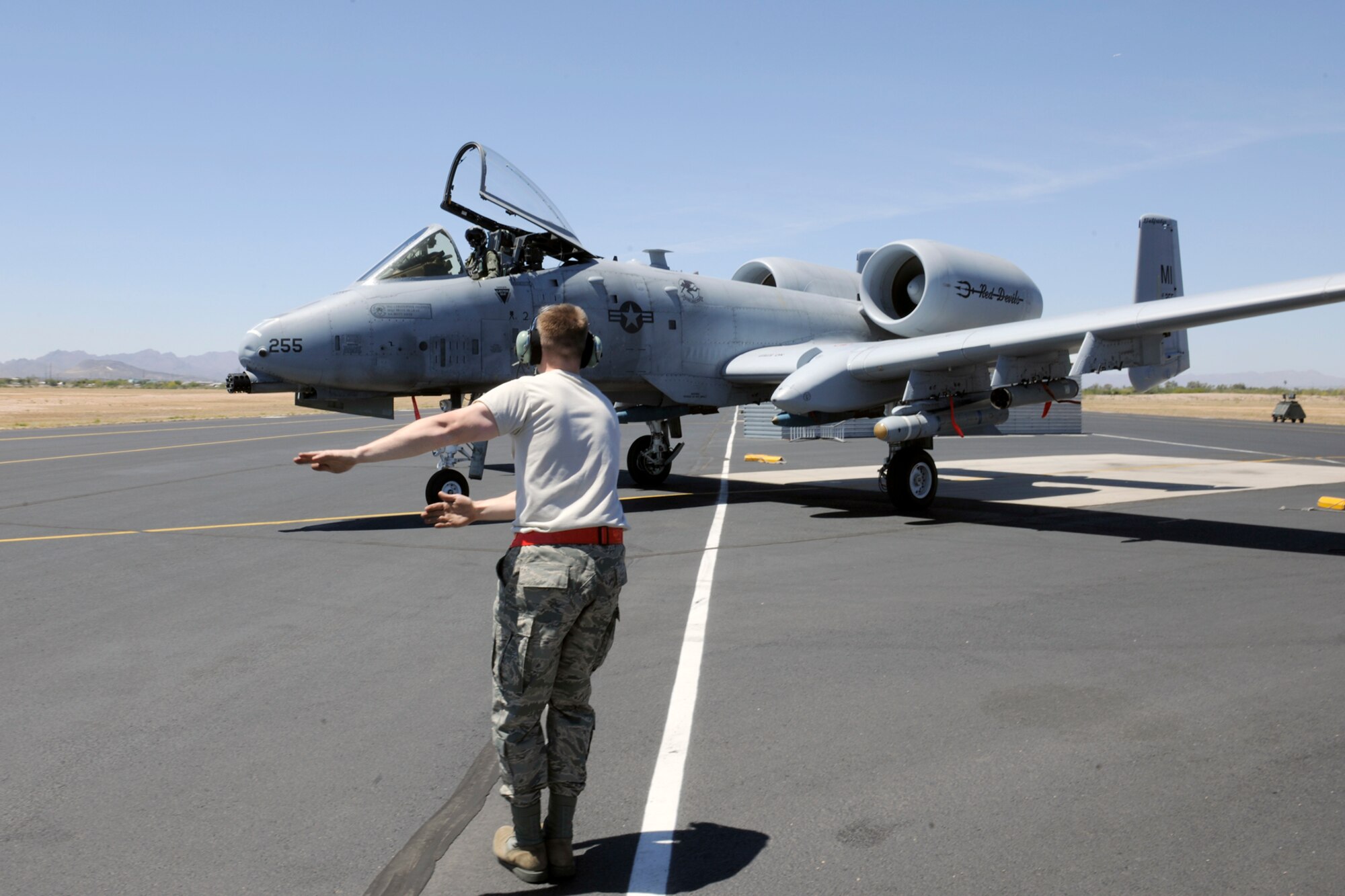 140428-Z-EZ686-011— Senior Airman Brett Baver, a crew chief of the 127th Aircraft Maintenance Squadron, marshals an A-10 Thunderbolt II aircraft from Selfridge Air National Guard Base Mich., to the flight line, during the 2014 Operation Snowbird/Angel Thunder training mission at Davis-Monthan Air Force Base, Tucson, Ariz., April 26, 2014.  Baver marshaled one of the first few A-10 Thunderbolt II aircraft to the flight line that commenced the operation Angel Thunder training mission.  (U.S. Air National Guard photo by MSgt. David Kujawa/Released)