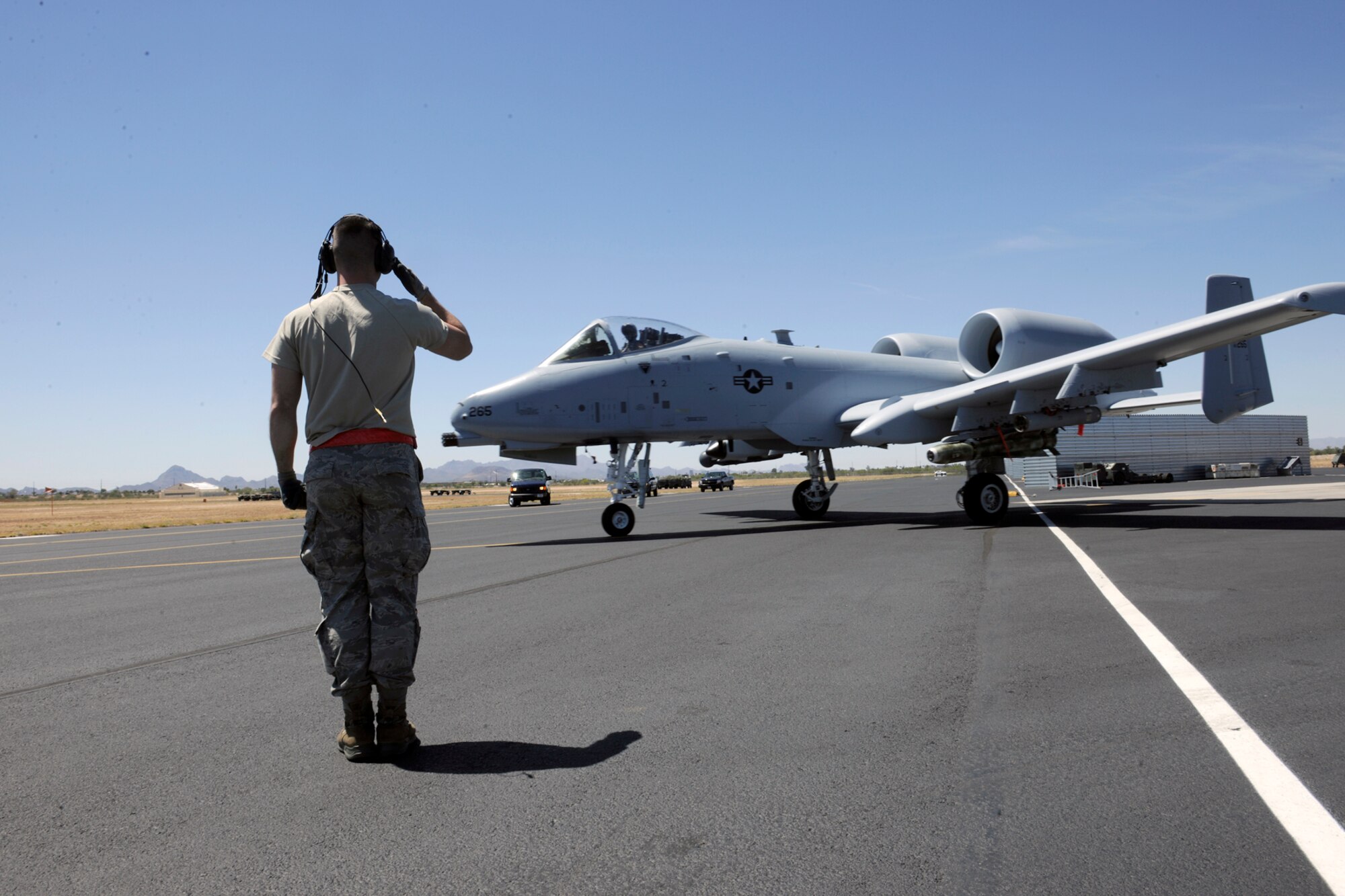 140428-Z-EZ686-017 — Senior Airman Joseph DiGiovanni, a crew chief of the 127th Aircraft Maintenance Squadron, salutes the A-10 Thunderbolt II pilot after marshaling the aircraft from Selfridge Air National Guard Base Mich., to the flight line, during the 2014 Operation Snowbird/Angel Thunder training mission at Davis-Monthan Air Force Base, Tucson, Ariz., April 26, 2014.  DiGiovanni marshaled one of the first few A-10 Thunderbolt II aircraft to the flight line that commenced the operation Angel Thunder training mission.  (U.S. Air National Guard photo by MSgt. David Kujawa/Released)