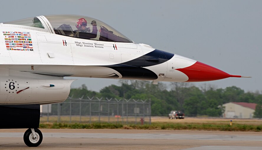 U.S. Air Force Thunderbird #6, piloted by Capt. Jason Curtis, waves as he taxis to the runway during the Defenders of Liberty Air Show at Barksdale Air Force Base, La., April 26, 2014. Curtis has logged more than 1,750 flight hours as an Air Force pilot, with more than 280 hours of combat experience in the F-16C. (U.S. Air Force photo/Senior Airman Kristin High)